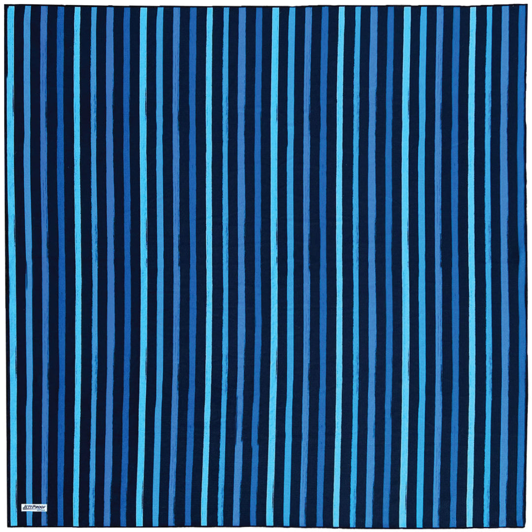 Laid out oversized sand-free towel featuring varies shades of blue stripes on a black background