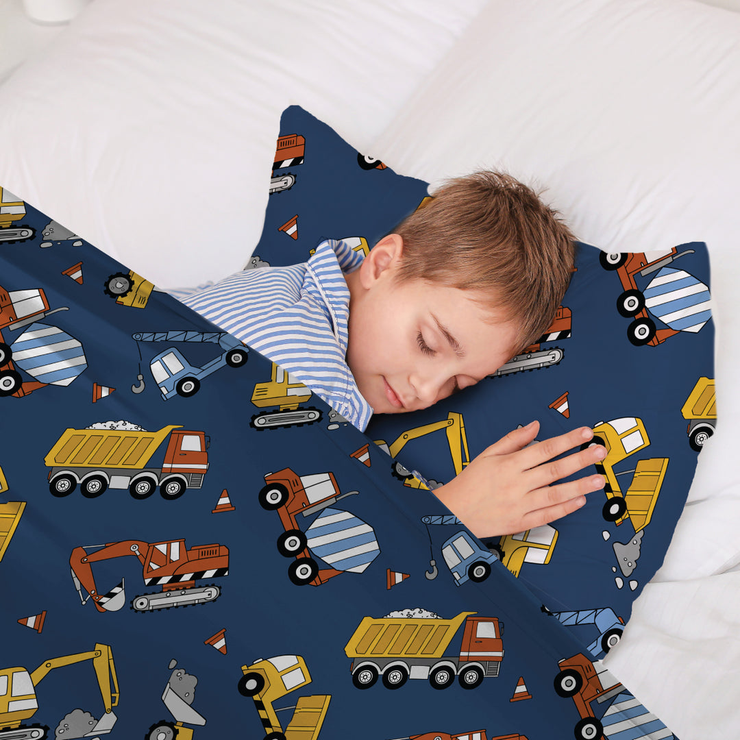Young bed sleeping in truck print bedspread with matching sensory pillowcase