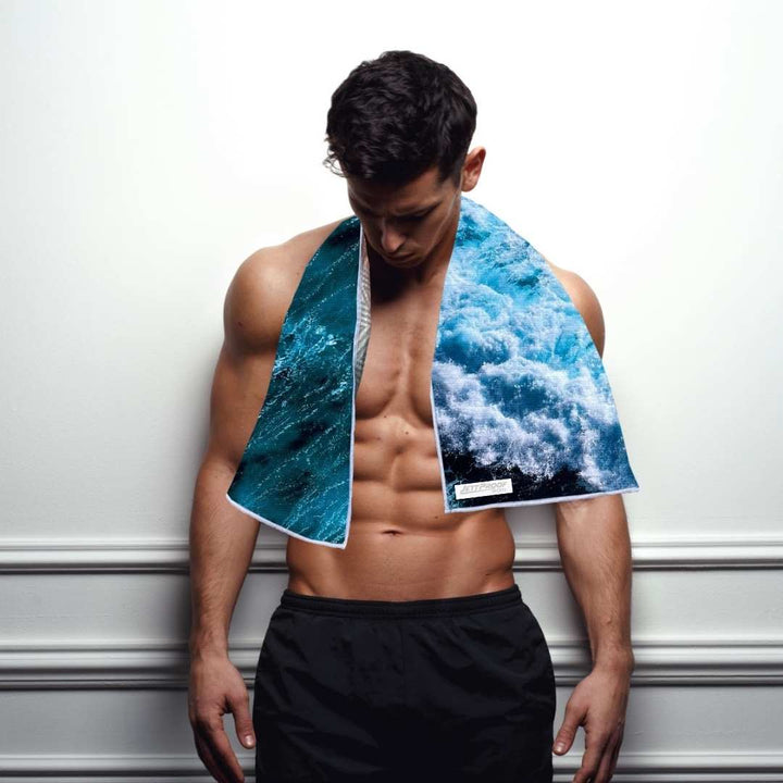 Man with antibacterial gym towel with Ocean print by JettProof