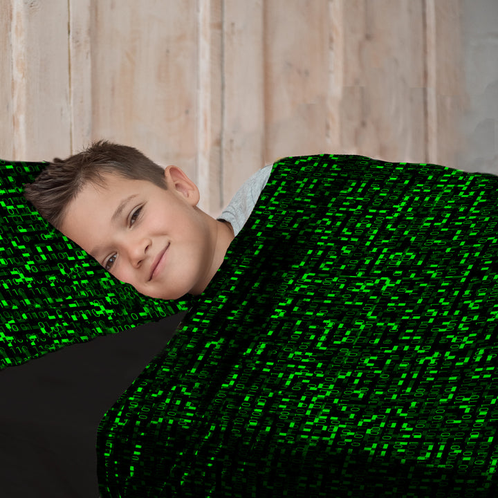 boy in matrix patterned sensory compression sheets with matching pillowcase and slate gray fitted sheets