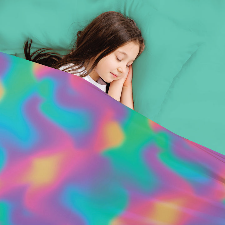 Young girl asleep in beautiful colorful Ombre sensory Compression sheets by JettProof