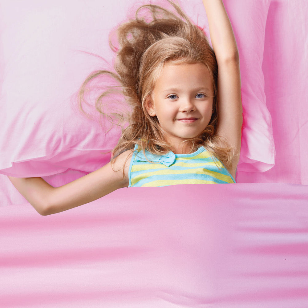 young girl in pink sensory compression bedsheets by JettProof