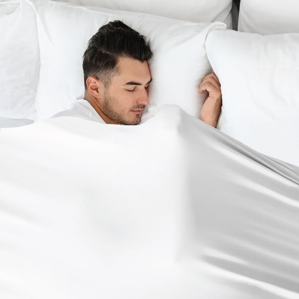Man in white calming compression sheets by JettProof